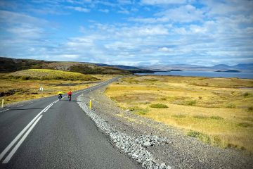 2 cyclists riding along a deserted coastal road were the scenery is always superb and unobstructed by forests on our Iceland South Bike Tour