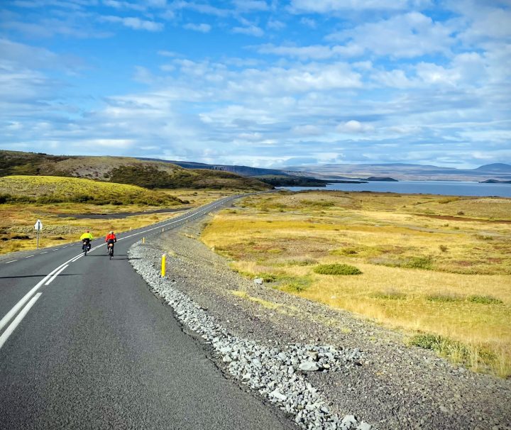 2 cyclists riding along a deserted coastal road were the scenery is always superb and unobstructed by forests on our Iceland South Bike Tour