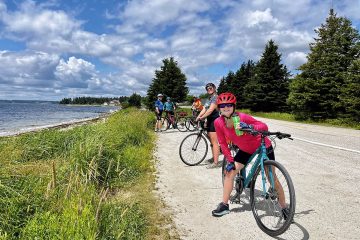 This image shows a group of cyclists enjoying a ride on a scenic trail on the south shore of Nova Scotia