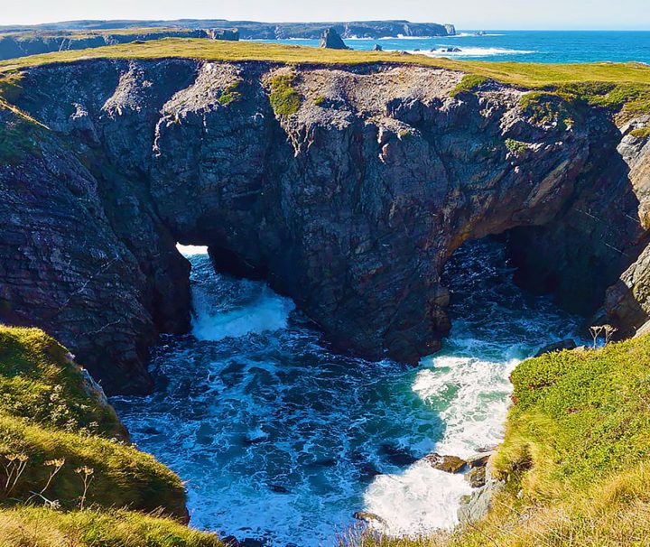 2 natural arches formed by collapse of a former sea cave. Dungeon Provincial Park, Bonavista Peninsula, Eastern Newfoundland, Canada.