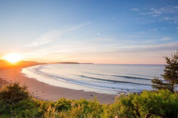 A typically beautiful sunset view of one of the beaches you will visit during the Mabou & Celtic Shores Coastal Trail cycling tour with Freewheeling Adventures.