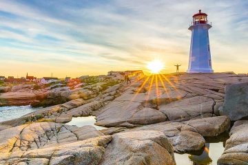 A sunset view of the lighthouse of the famous Peggy's Cove in Nova Scotia on our South Shore Hike