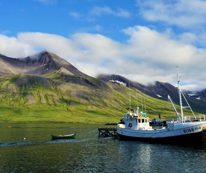 Wooden Icelandic fishing boat in Siglufjörður bay. Icelandic fjords.