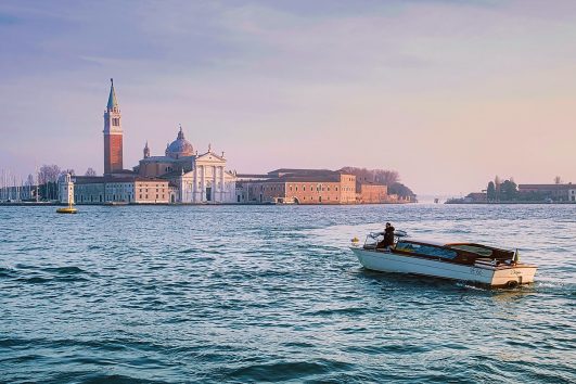 A view from the water of seaside village on Venice, Italy on the Italy: Innsbruck to Venice Bike Tour with Freewheeling Adventures.