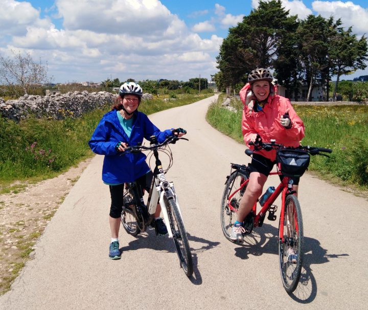 Happy cyclists posing on a traffic free biking path on a Freewheeling Adventure tour in Puglia Italy.