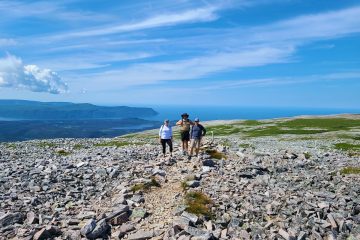 This image captures a group hiking the Gros Morne Mountain trail in Newfoundland and Labrador, Canada