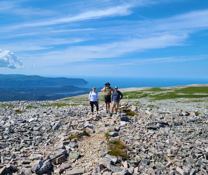 This image captures a group hiking the Gros Morne Mountain trail in Newfoundland and Labrador, Canada