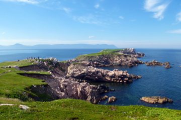 This image shows a scenic view of the coastal cliffs at White Point on Cape Breton Island, Nova Scotia