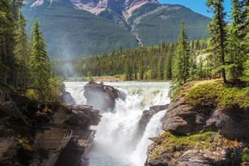 The image displays Athabasca Falls, a powerful waterfall located in Jasper National Park, Alberta, Canada