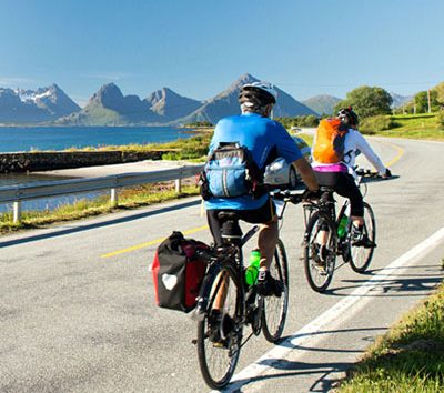 This image shows a scenic cycling tour through the Lofoten Islands in Norway