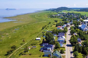 This image shows a scenic aerial view of the village of Saint-André-de-Kamouraska in Quebec