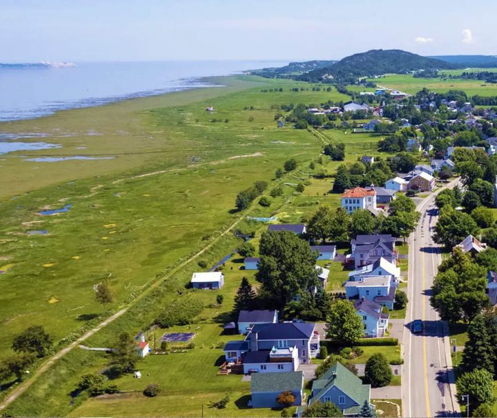 This image shows a scenic aerial view of the village of Saint-André-de-Kamouraska in Quebec