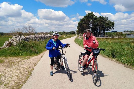 This image shows a moment from a guided bicycle tour in southern Italy, specifically touring through the Puglia and Basilicata regions